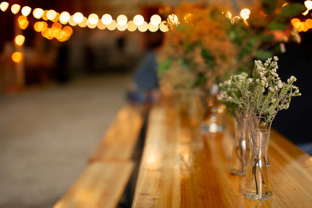 Bouquet of wild flowers on a wooden table and a rustic market