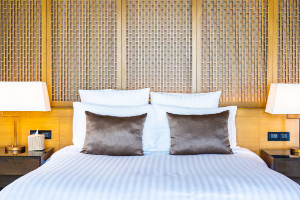 istock Beautiful luxury comfortable white pillow on bed and blanket decoration in bedroom 1159951116