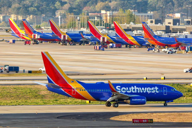 Southwest Airlines Boeing 737-700 airplanes Atlanta airport Atlanta, Georgia – April 3, 2019: Southwest Airlines Boeing 737-700 airplanes at Atlanta Airport (ATL) in the United States. southwest stock pictures, royalty-free photos & images