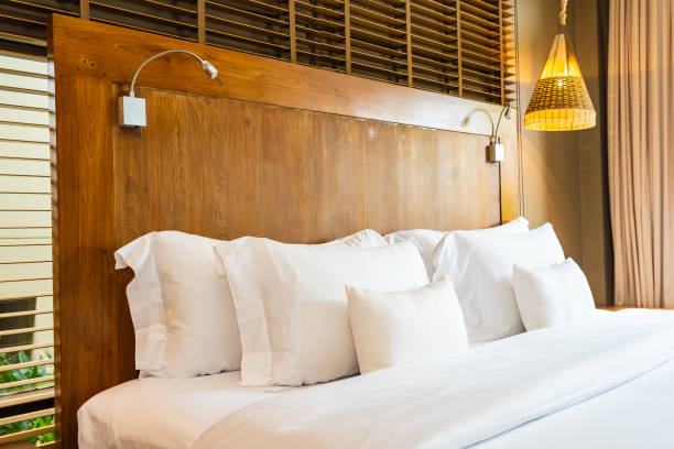 istock Beautiful luxury comfortable white pillow on bed and blanket decoration in bedroom 1159953210