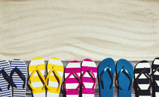 istock Set of colorful flip flops on the beach deck 1159959923