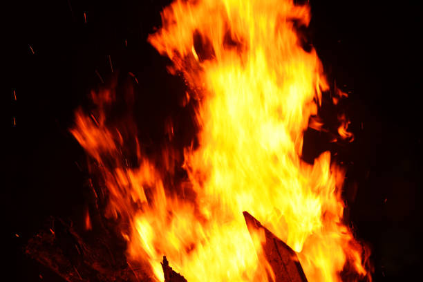 istock bonfire night campfire wood burning flame on dark black 1159961180