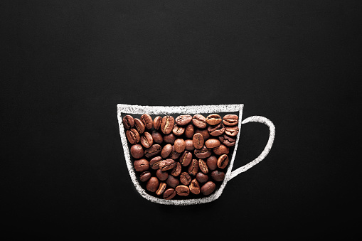 coffee cup drawn with chalk on blackboard with coffee beans