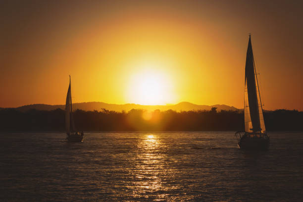 istock Silhouette Sailboat On Sea Against Sky During Sunset 1159963044