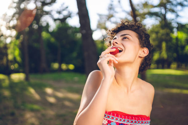 istock Lady with a strawberry 1159967316