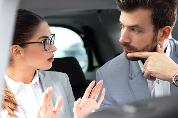 istock Young business people working together while traveling by a car. 1159968353