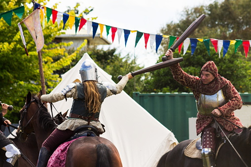 Levin, New Zealand - February 10th, 2017: Two people reenacting a medieval horseback sword fight at the  annual Medieval Market which attracts thousands of locals and tourists every year.