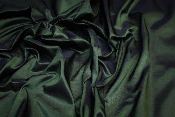 istock Silk fabric, taffeta. Green colour. Texture, background, pattern. 1159968499