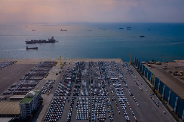 istock Aerial view in evening scene with Container ship in export and import business and logistics. Shipping cargo to harbor by crane. Water transport International. 1159968580