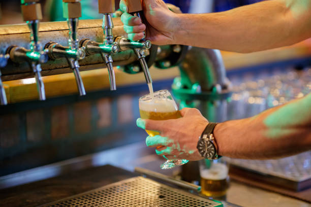 istock Pouring beer from the tap with foam 1159970958