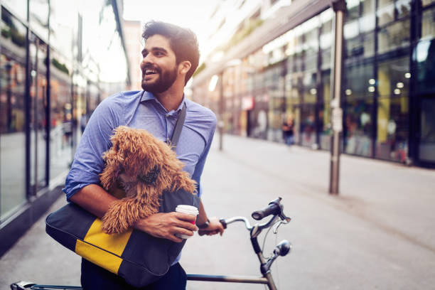 istock Handsome business man on street drinking coffee with dog 1159971309