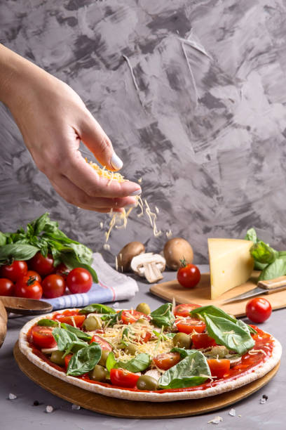 istock Fast homemade vegetarian pizza with mushrooms on a gray table 1159971363
