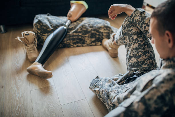 istock Disabled veteran US soldier with one leg at home 1159972185