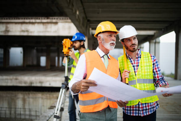 istock Team of architects and engineer in group on construciton site check documents and business workflow 1159972190