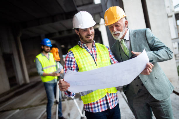 istock Team of business people in group, architect and engeneer on building site check documents 1159972317