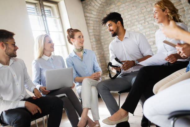 istock Successful happy group of people learning software engineering and business during presentation 1159973903
