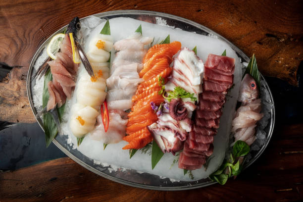 istock Sashimi from different types of fish on ice. Top view. 1159975426