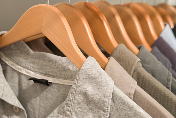 Shirts hanging on wooden hangers.