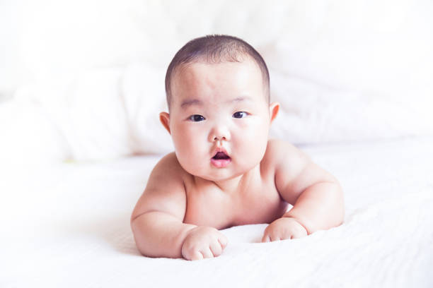 istock little baby lying on bed 1159978077
