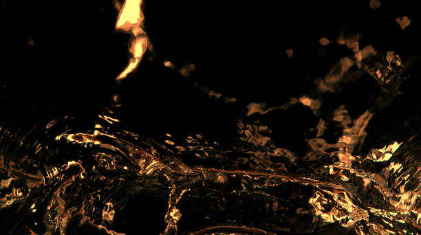 istock Golden splashes isolated on black background 1159978204