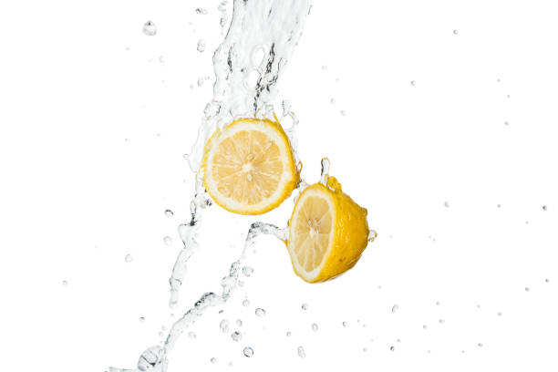 istock yellow cut lemons with clear water splash and drops isolated on white 1159981448