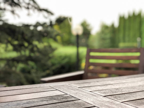 wooden table and chair at a garden stock photo