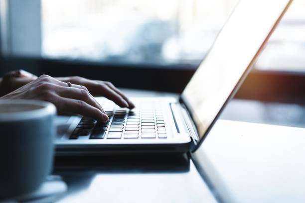 istock woman using laptop, searching web, browsing information, having workplace at home or in creative office or cafe. 1159981545