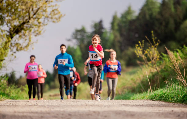 istock Large group of multi generation people running a race competition in nature. 1159982815
