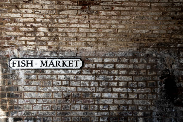 istock Old stone wall with Fish Market road sign 1159983739
