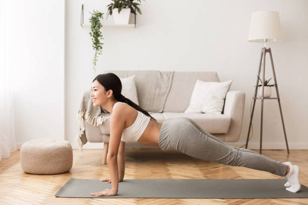 istock Girl Standing in Plank Pose, Working Out at Home 1159987968