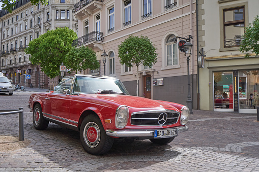 Baden Baden, Germany - april 24, 2019: Beautiful red retro car cabriolet Mercedes Benz 280 on the street of the European city
