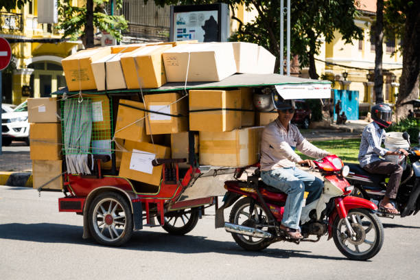 Phnom Penh, Cambodia - December 01, 2018. The Tuk Tuk is one of the most common forms of transport. They are often used as a taxi or for transporting heavy items or food carts. There is very little regulation in terms of what can and can not be loaded and transported throughout the city.