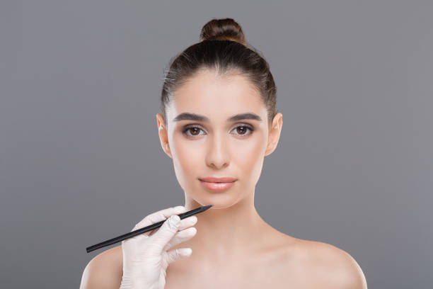 istock Millennial woman and doctor's hand with pencil 1159989046