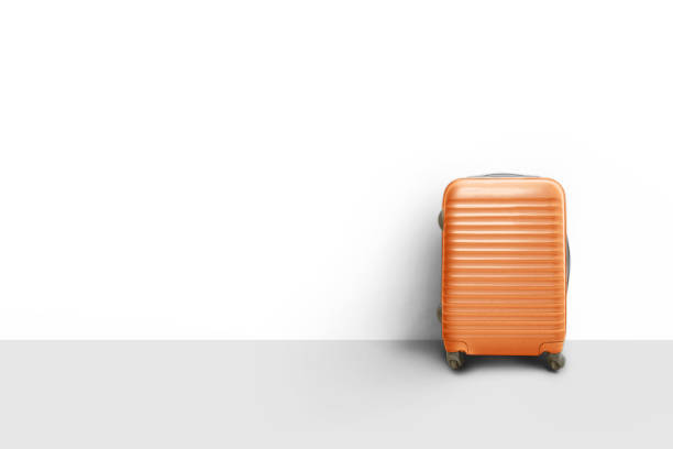 istock Orange suitcase standing next to the wall, Travel concept 1159989411