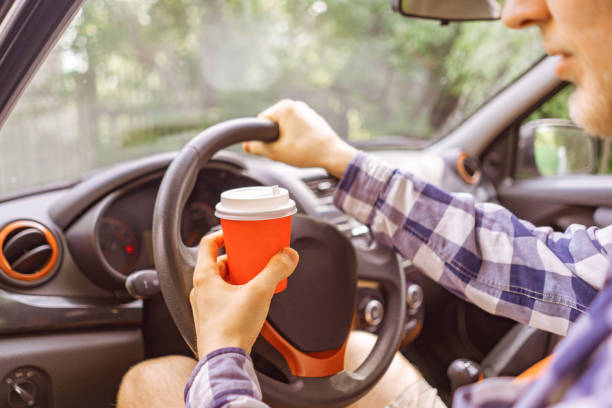 istock drinking coffee in paper cup during the journey in the car 1159989765