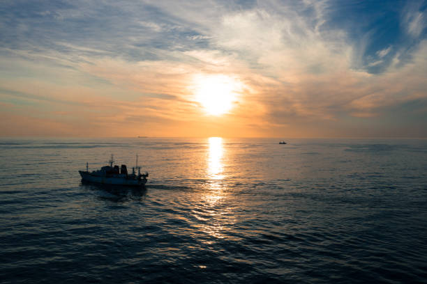 Full length shot of a ship at sea during a sunset