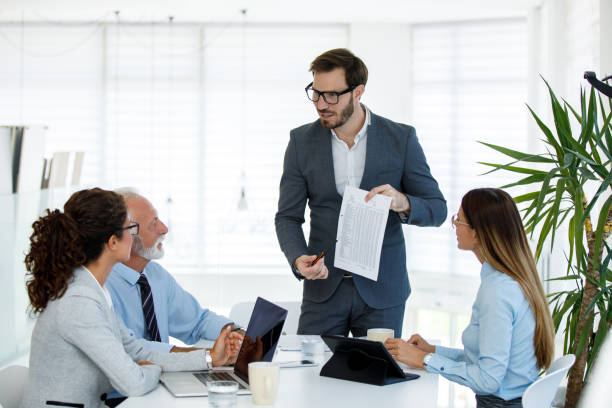 istock Business people having board meeting in modern office 1159990512