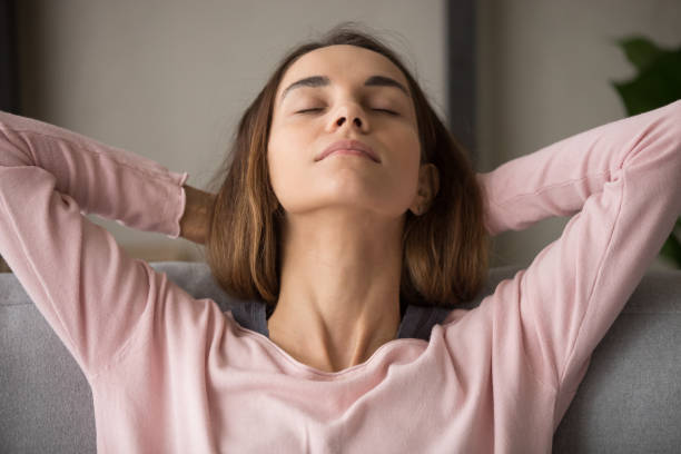 Close up front view woman closed eyes resting on couch