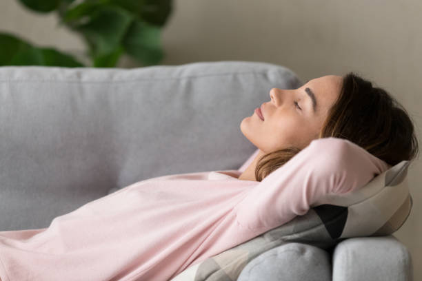 istock Side close up view woman having day nap on couch 1159994554