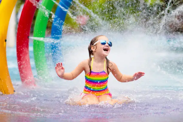 Photo of Kids at aqua park. Child in swimming pool.