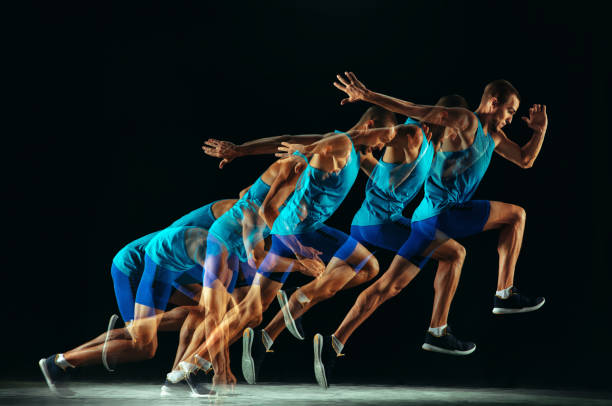 istock Professional male runner training isolated on black studio background in mixed light 1159995386