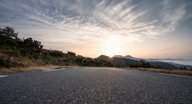 istock Empty long road on a sunny summer day at bright sunset 1159996132