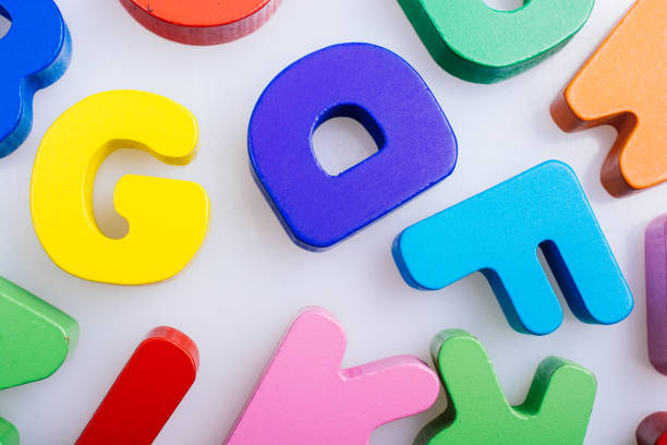 istock Colorful wooden letters on a white background 1159996174