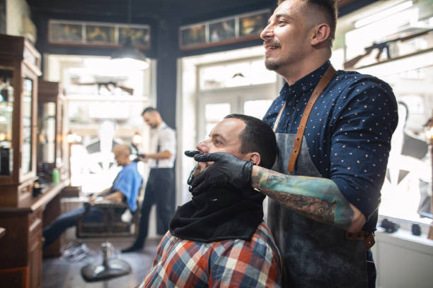 istock Man sitting in a barber shop preparing for a fresh shave 1159996504