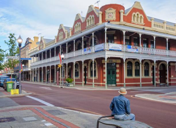 P&O Hotel - Fremantle Fremantle, WA, Australia - December 8, 2014: A tourist is admiring the heritage listed P&O Hotel at the corner of Mouat Street and High Street traditionally australian stock pictures, royalty-free photos & images