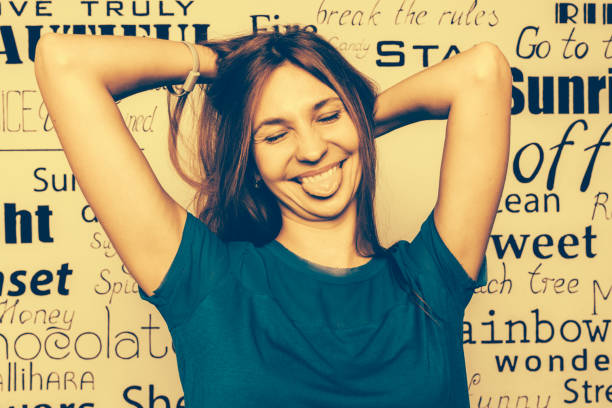 Shocked excited woman showing with hands big and large size measure symbol, looking at camera with wide toothy surprised smile isolated on blue studio wall. Promotion and advertisement concept