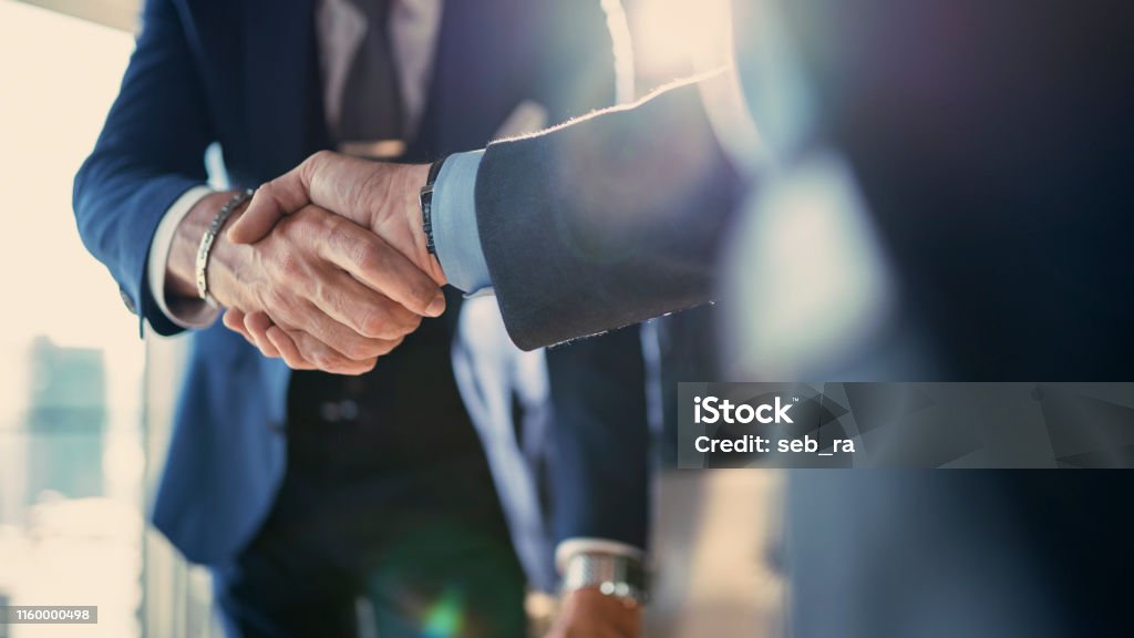Business partnership meeting in office Handshake Stock Photo