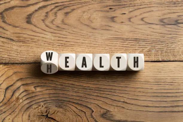 Photo of Letters on blocks spelling wealth or health