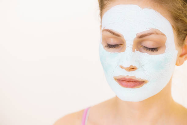 istock Girl with green mud mask on face 1160000577