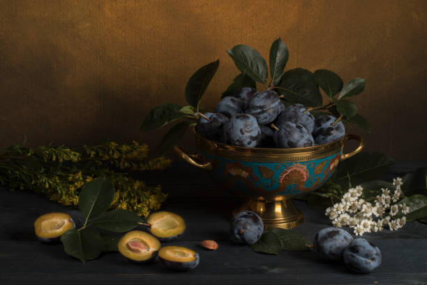 istock Plum in a vase on a table with flowers 1160000582